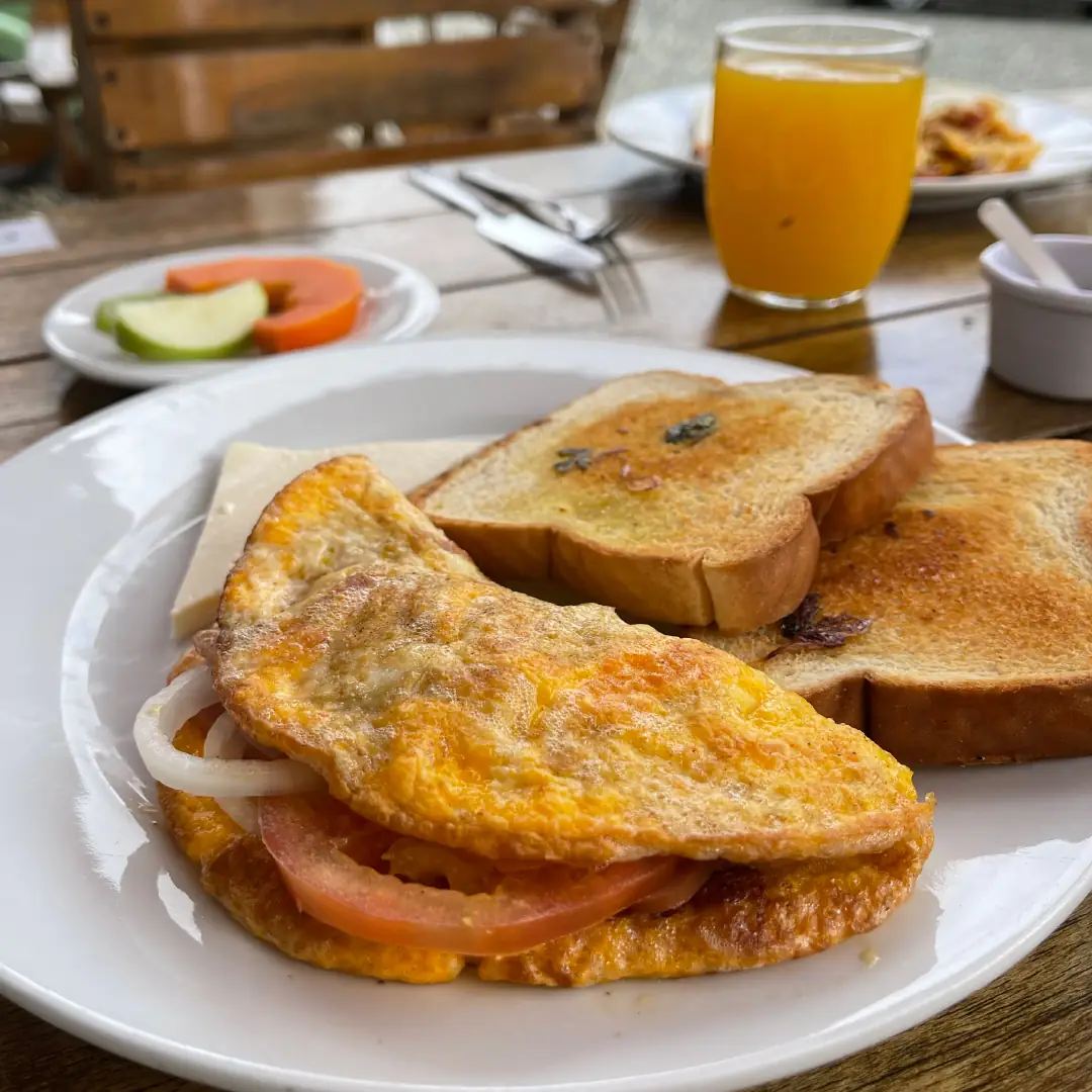 Breakfast served in the hotel restaurant: eggs, toast, fruit and juice.