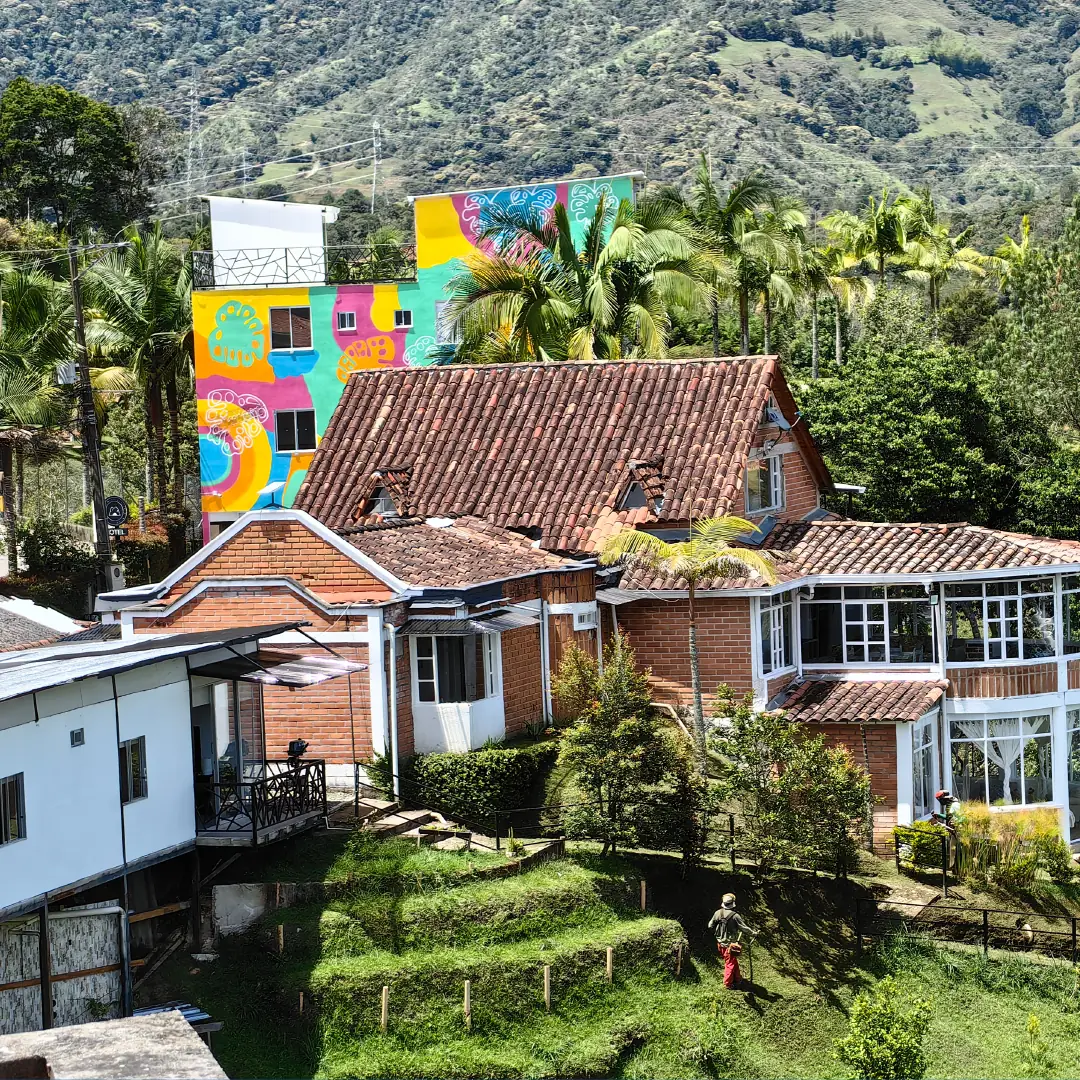 Aerial view of the hotel and the coloured houses of Guatapé among the mountains.