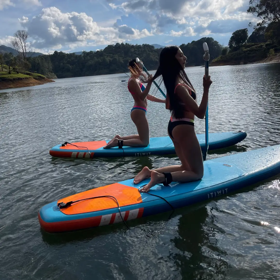 A guest standing on a paddleboard on the reservoir.